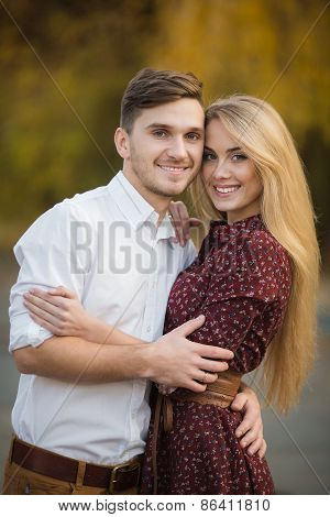 Young couple in love outdoors in autumn in the park.