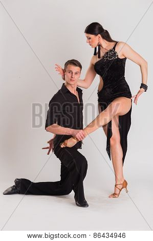 Man and woman posing in dance pose on white