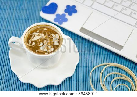 Cup Of Coffee With A White Lap Top