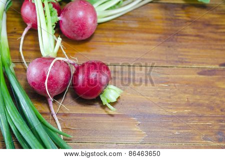 Raw Radishes On A Wooden Table
