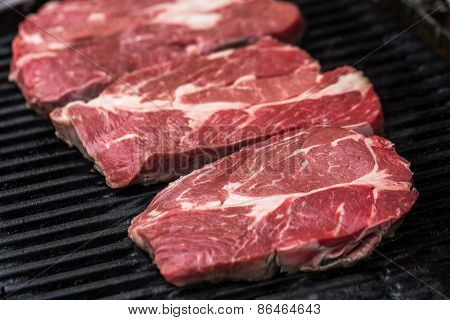 Fresh beef steaks on grill