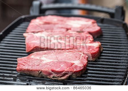 Fresh beef steaks on grill