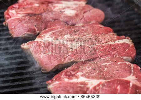 Fresh beef steaks on grill