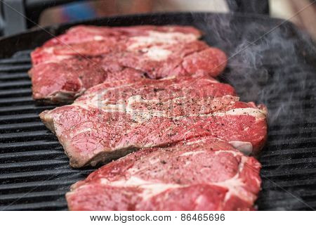 Fresh beef steaks on grill