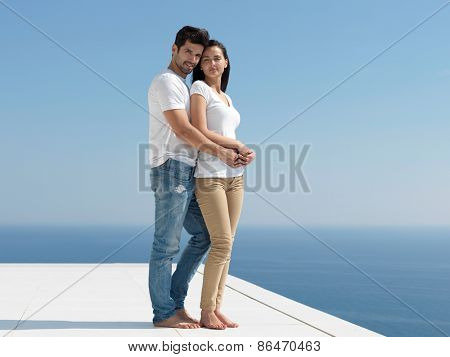 happy young romantic couple have fun relax smile at modern home outdoor terace balcony terace