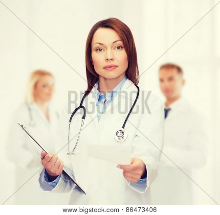 healthcare and medicine concept - calm female doctor with clipboard and stethoscope