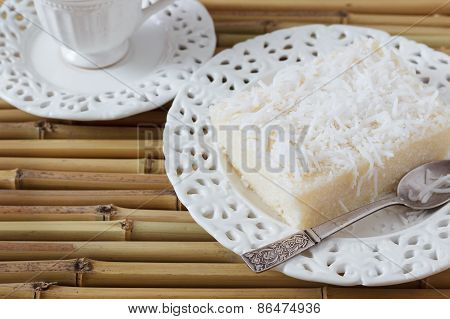 Sweet Couscous Pudding (cuscuz Doce) Coconut On Vintage Plate, Cup Of Coffee On Bamboo