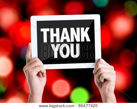 Tablet pc with text Thank You with bokeh background