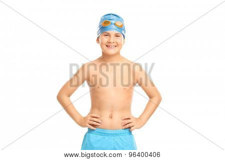 Joyful little kid with a blue swim cap and orange swimming goggles looking at the camera isolated on white background
