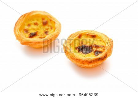 Two Single Portuguese Egg Tarts On A White Background