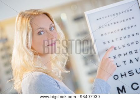 Lady pointing at eye test chart