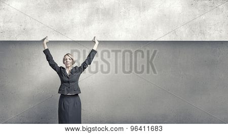 Yoiung pretty woman holding blank banner with place for text