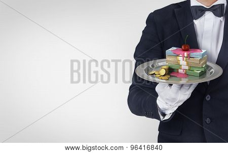 Waiter Hold Restataunt Cloche With Stack Of Money Poured Syrup With A Cherry On Top. Concept Of Pers