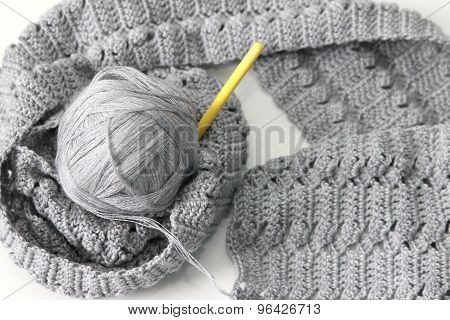 gray scarf with thread and hook