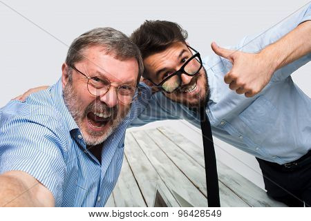Two colleagues  taking the picture to them self sitting in  office