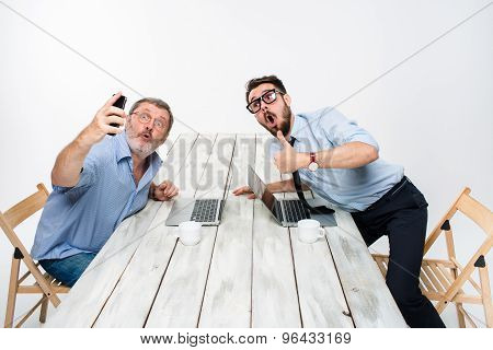 Two colleagues  taking the picture to them self sitting in office