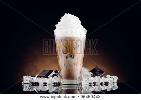 Iced Coffee In Glass And Crushed Ice On Brown Background