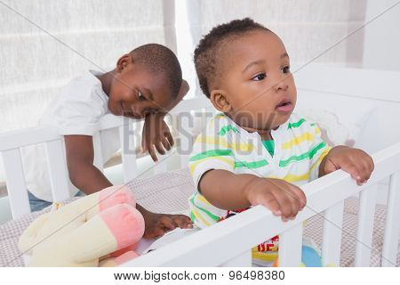 Babyboy and his brother in babyroom at home in babyroom