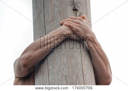 Man climbing the pole for prize during winter carnival Maslenitsa in Russia.