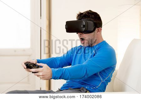 young modern man at home living room sofa couch playing video game excited using 3d goggles watching 360 virtual reality vision enjoying the fun cyber experience in vr simulation reality concept