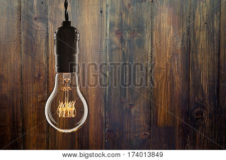 Vintage Incandescent Edison Type Bulb On Wooden Background