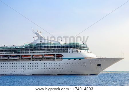White cruise ship underway. Passenger ship leaving port of Riga