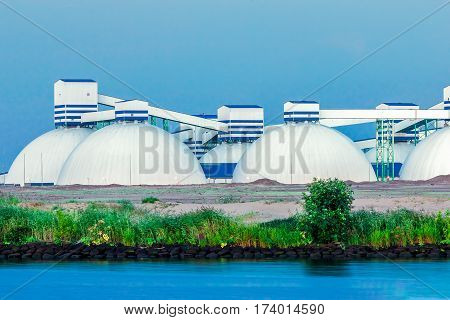 Riga fertilizer terminal with saltpeter against river coast