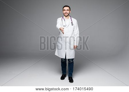 Full length young medical doctor on white background