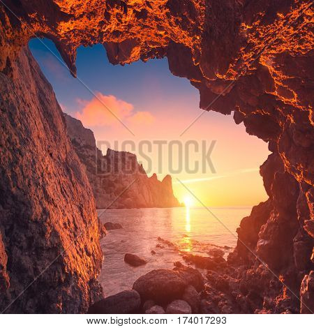 Beautiful sunrise from the mountain cave in a Crimea sea bay