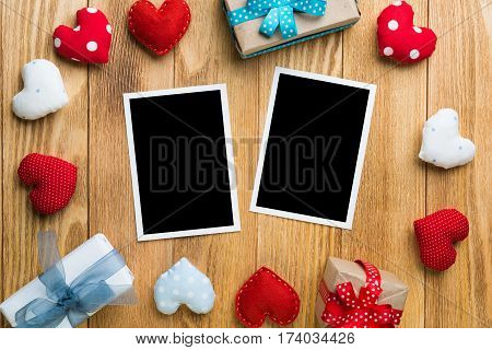 Blank instant photo and love hearts on wooden table background