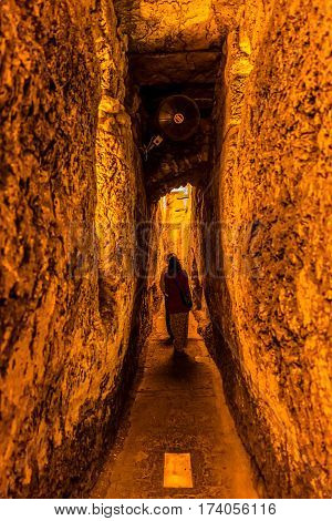 JERUSALEM, ISRAEL - MAY 23, 2016: Narrow passage in Western Wall tunnel, foot of the western side of the Temple Mount in old city.