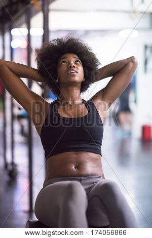 young fit african american woman doing sit ups in fitness studio at the gym.Abdominal exercises Sit up
