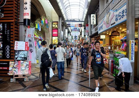 Japanese People And Traveler Foreigner Walking At Small Alley In Higashimuki Shopping Street For Tra