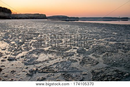 Sunset and ice on the lake in the spring