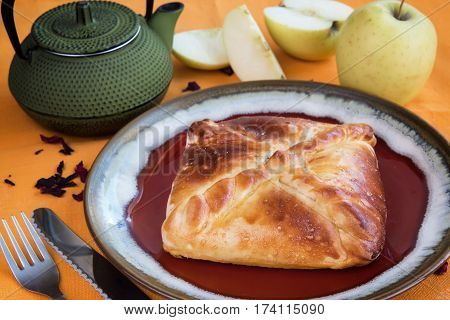 bun with apple tea on an orange background