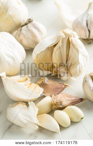 Peeled fresh garlic on kitchen table.