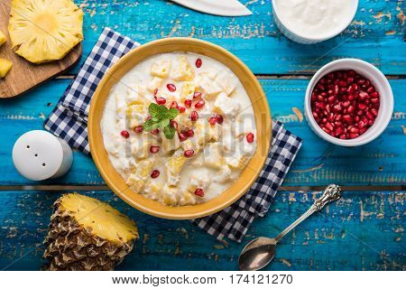 ananas or anaanaas or pineapple raita, chopped pieces of pineapple mixed with sweet curd and garnished with pomegranate and mint, favourite side dish or starter food in India