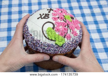Easter cake keep his hands on the table top view