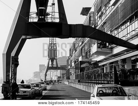 Historic Harbor Cranes In Monochrome