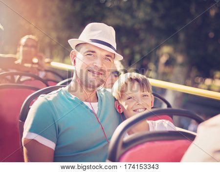 Father with his son traveling by tour bus