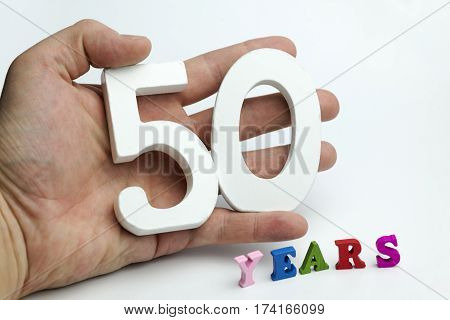 Hand holding number fifty on white background.