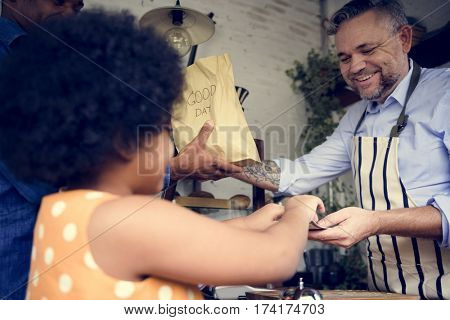 Customer Buying Fresh Baked Bread in Bakery Shop