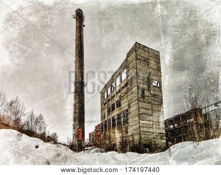 The old boiler and chimney on a background of the winter sky. Photos in a grunge style.