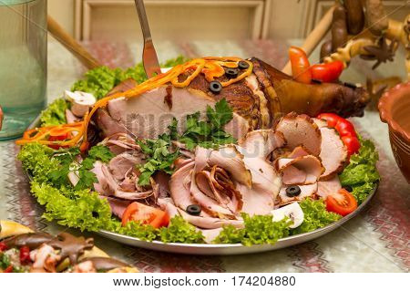 Pork leg sliced on a plate. Baked sliced meat. Roasted meat sliced