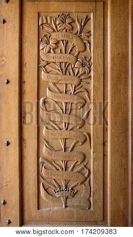 DEIR RAFAT ISRAEL - FEBRUARY 17 2017: Carved wooden panel doors in the church in the monastery of Dir Rafat with the inscription Ave Maria in different languages
