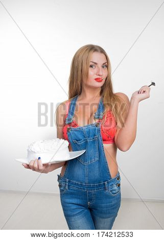 Busty sexy girl eating cake with whipped cream. white background