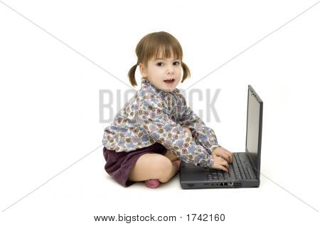 Kis lány dolgozik A laptop