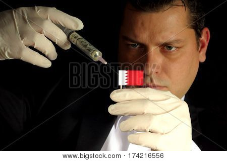 Young Businessman Gives A Financial Injection To Bahraini Flag Isolated On Black Background