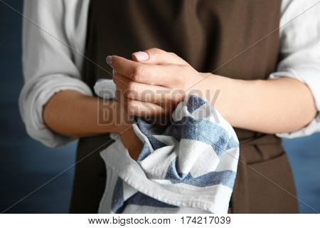 Woman in apron wiping her hands