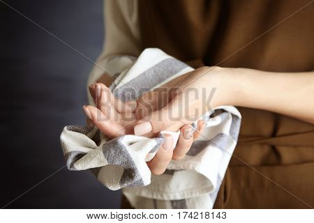 Woman in apron wiping her hands
